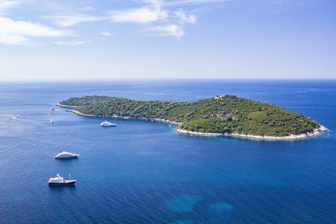 Panoramic view of Lokrum Island Dalmatian Coast of Adriatic Sea in Dubrovnik. Blue sea with white yachts, beautiful landscape, aerial view, Dubrovnik, Croatia